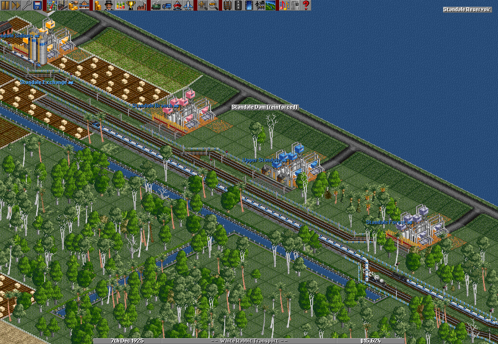 In the picture coming from... In the picture coming from the most respected server for OpenTTD, “Brianetta’s Standard”, a risky business is going on. Flooding always a possibility, a reinforced dam holds back a huge reservoir. Several water pumps draw water off for transport all across the desert, promising mountains of gold for those daring enough to supply the large number of plantations and farms out there.
